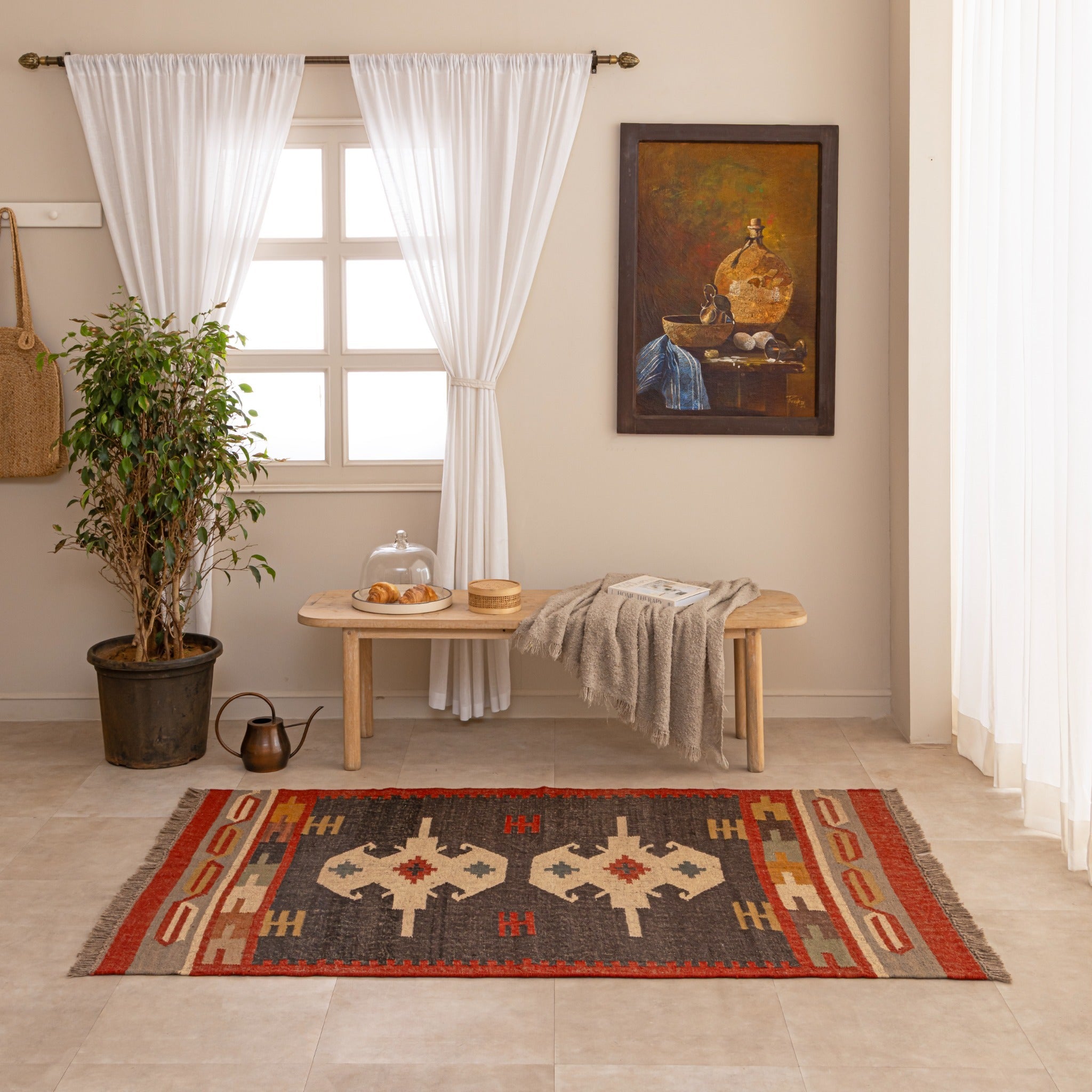 Handmade Southwestern tribal wool rug with geometric pattern in red, black, beige and mustard tones displayed in a cozy living room.