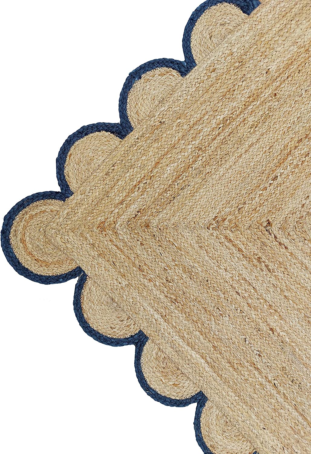 Handmade natural jute scalloped border area rug with blue trim in a bright farmhouse style living room.