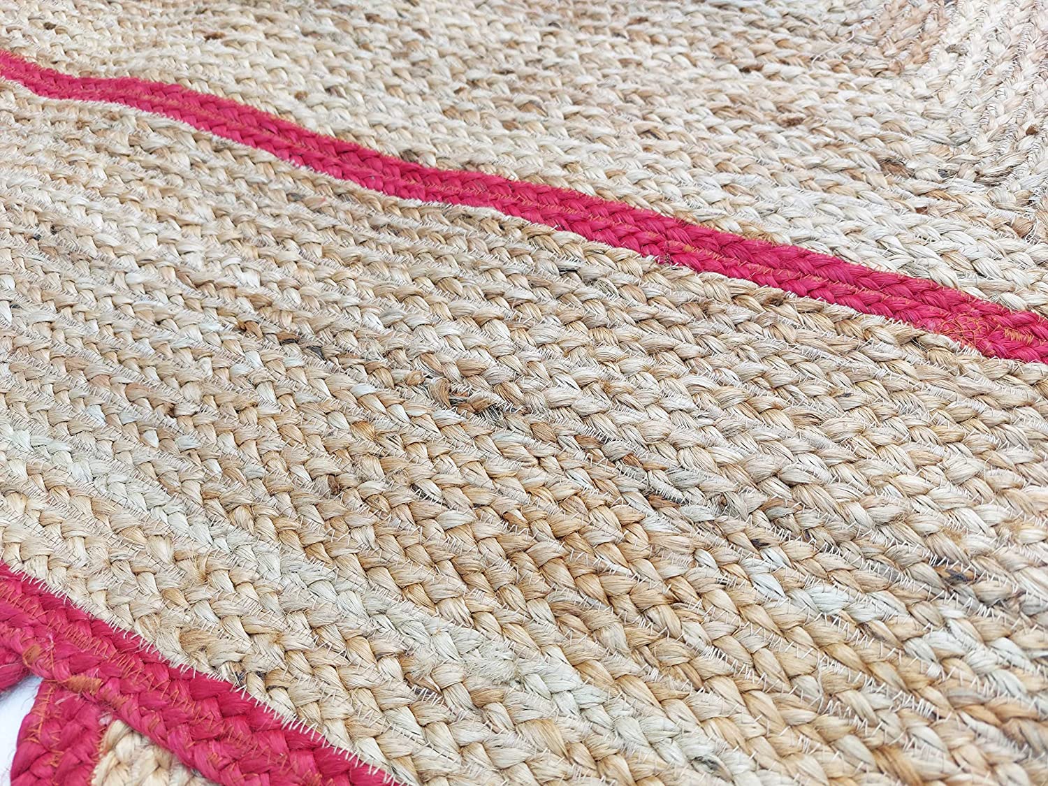 Modern living room featuring a handmade natural jute area rug with a red scalloped border, braided texture, wooden furniture, and Scandinavian boho home décor.