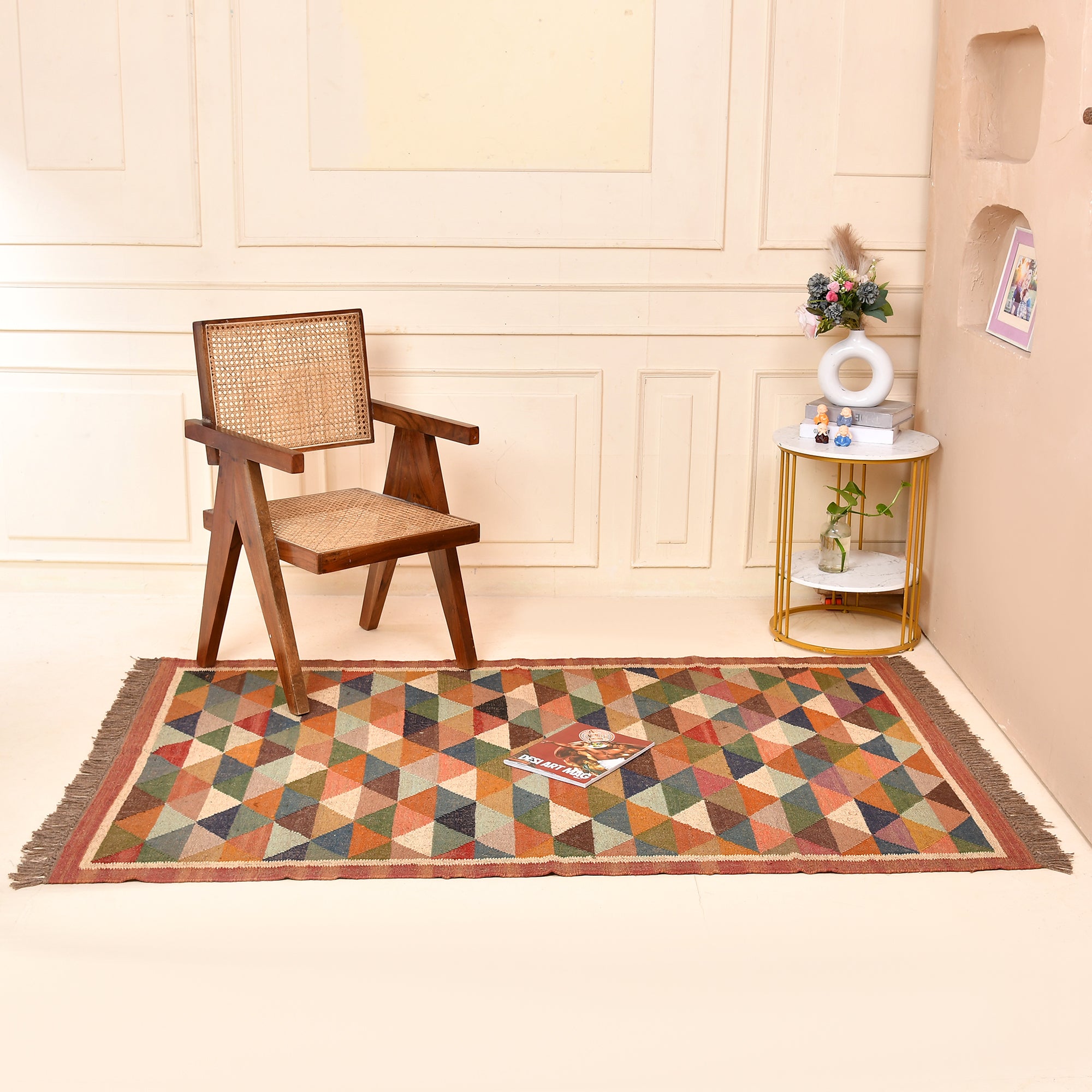 Handwoven terracotta diamond Kilim area rug with geometric tribal design, handmade from wool and cotton, styled in a modern living room with a wooden accent chair and side table.