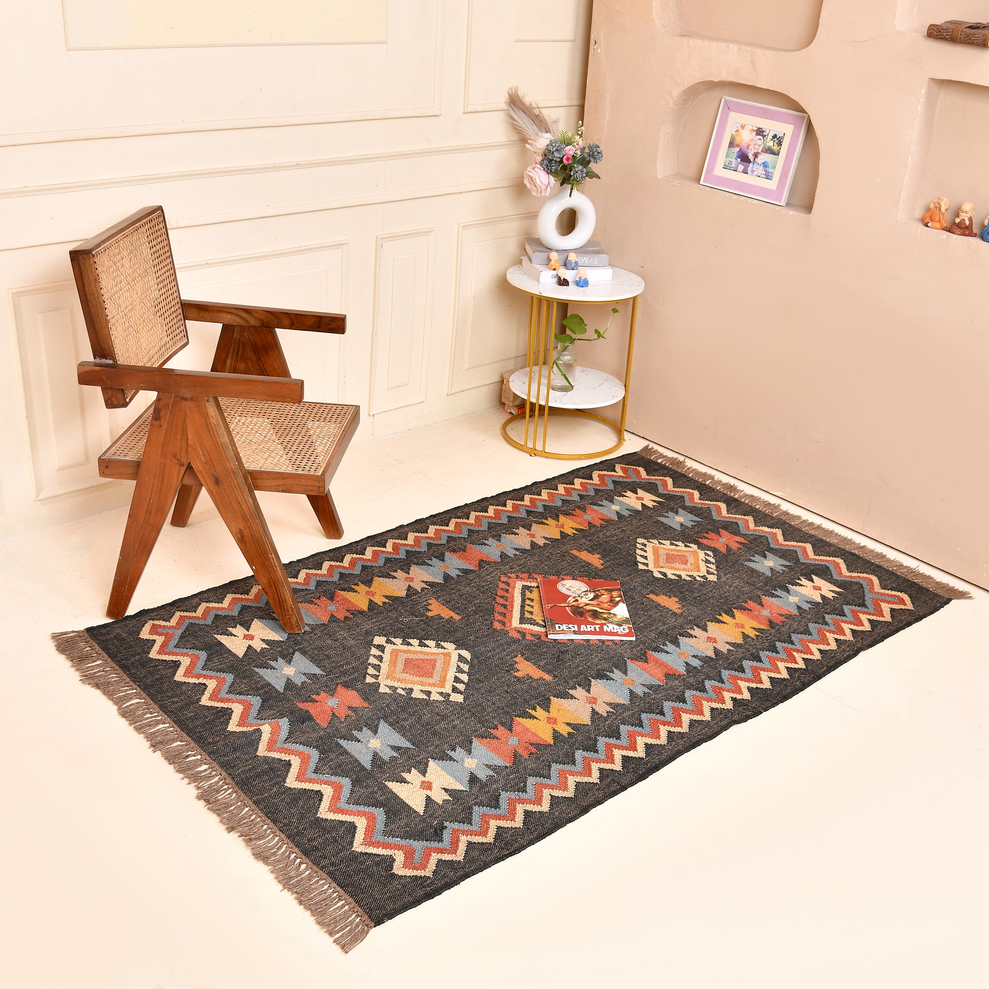 Handwoven charcoal grey wool and jute Southwestern tribal flatweave area rug with colorful geometric pattern.