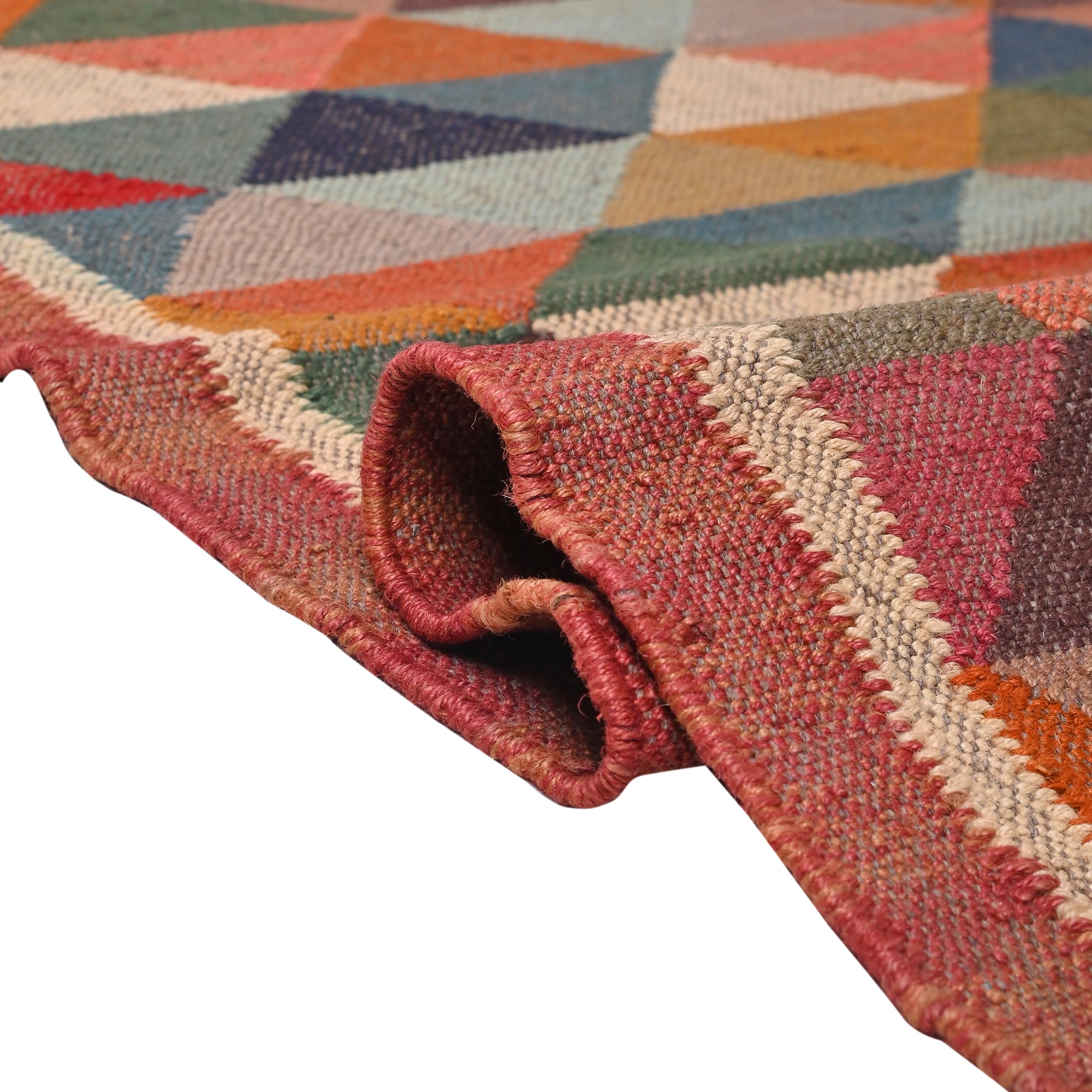 Handwoven terracotta diamond Kilim area rug with geometric tribal design, handmade from wool and cotton, styled in a modern living room with a wooden accent chair and side table.