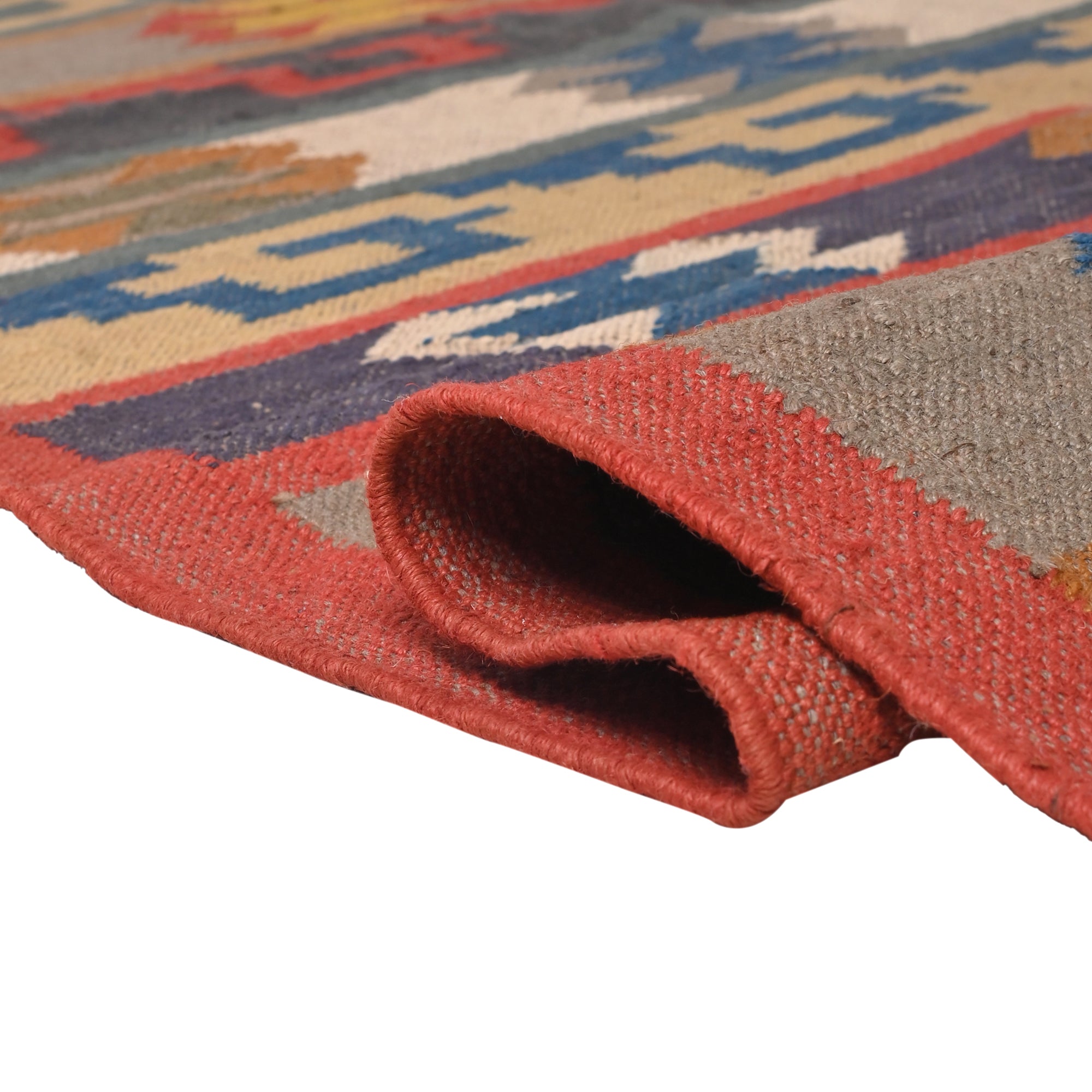 Handwoven Southwestern Kilim wool cotton area rug with colorful tribal geometric pattern in a modern living room.