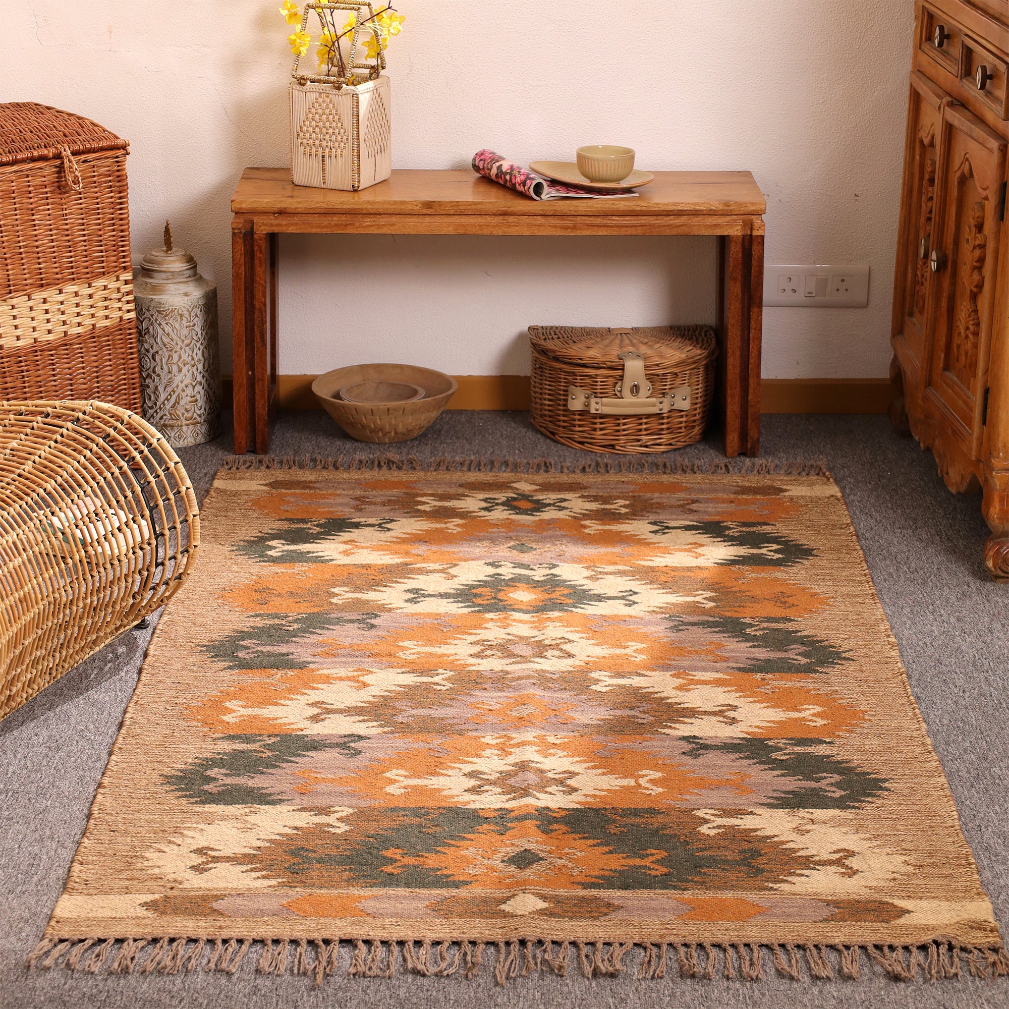 Handwoven jute kilim area rug with tribal geometric pattern in natural beige, rust orange, charcoal and cream for boho farmhouse home decor.