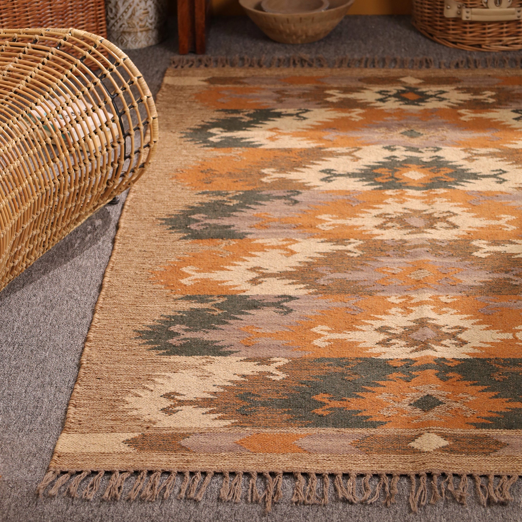 Handwoven jute kilim area rug with tribal geometric pattern in natural beige, rust orange, charcoal and cream for boho farmhouse home decor.