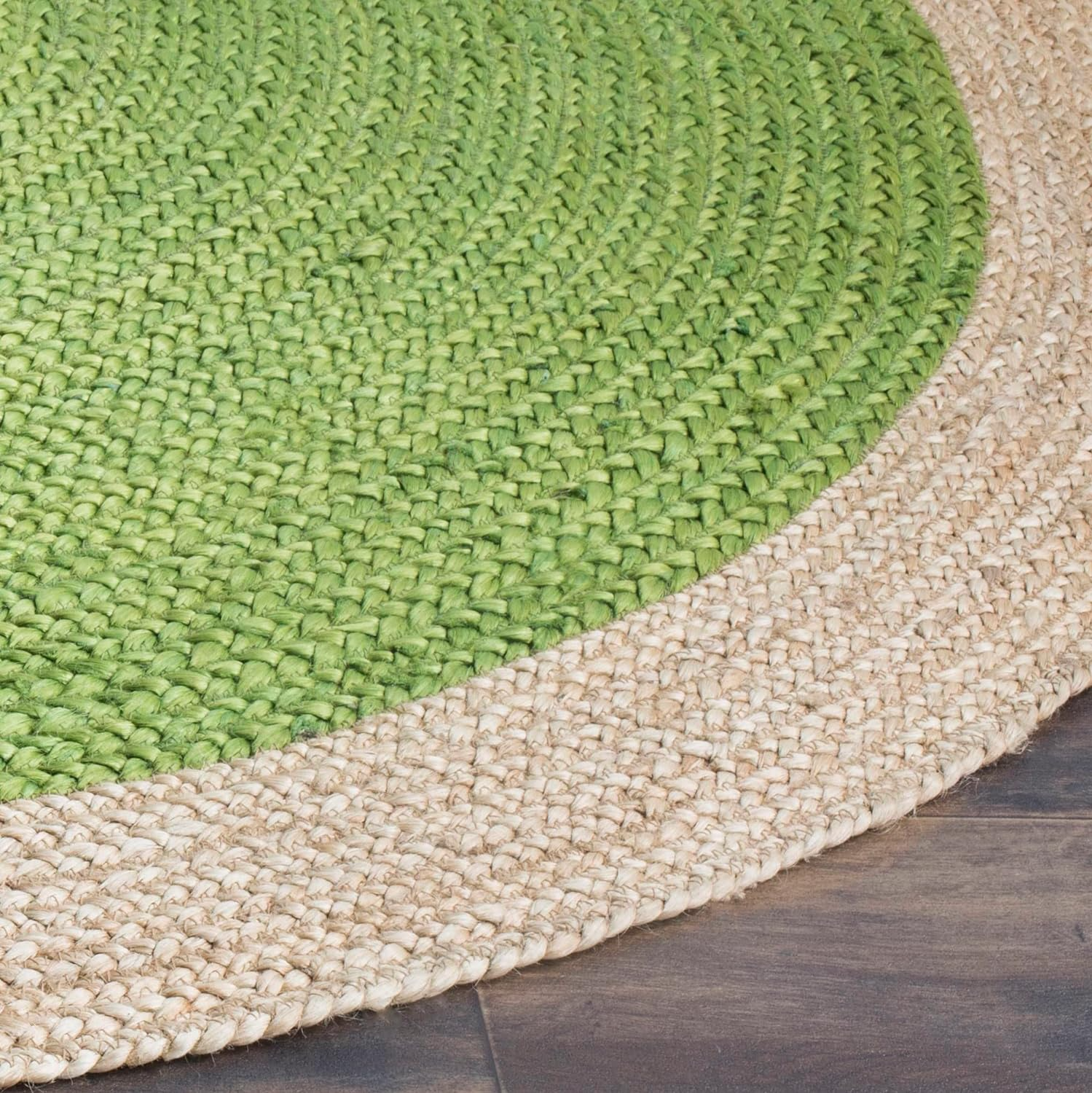 Handmade green round braided jute rug with a natural beige border in a cozy modern living room, featuring a wooden coffee table, neutral sofa, and indoor plants.