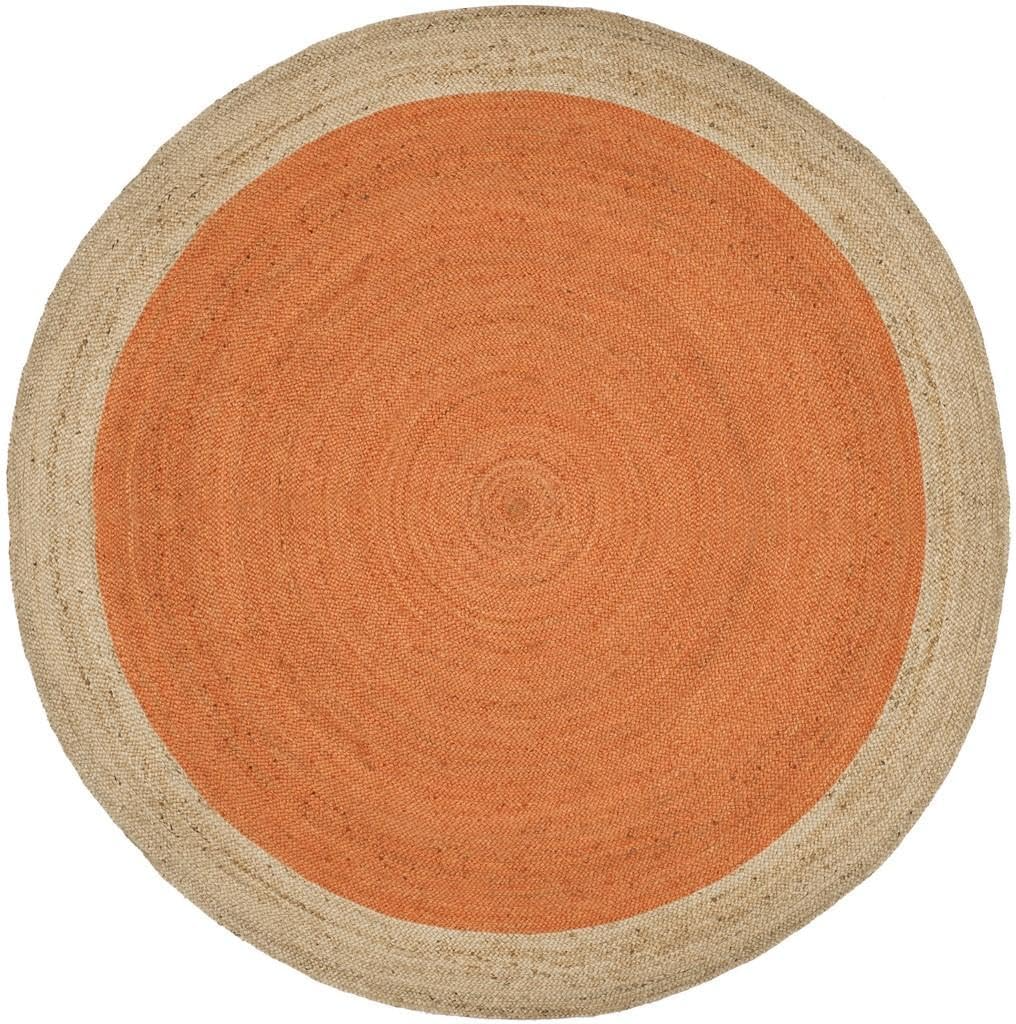 Handmade orange and natural jute round braided rug in a cozy boho living room with wooden coffee table and neutral sofa.