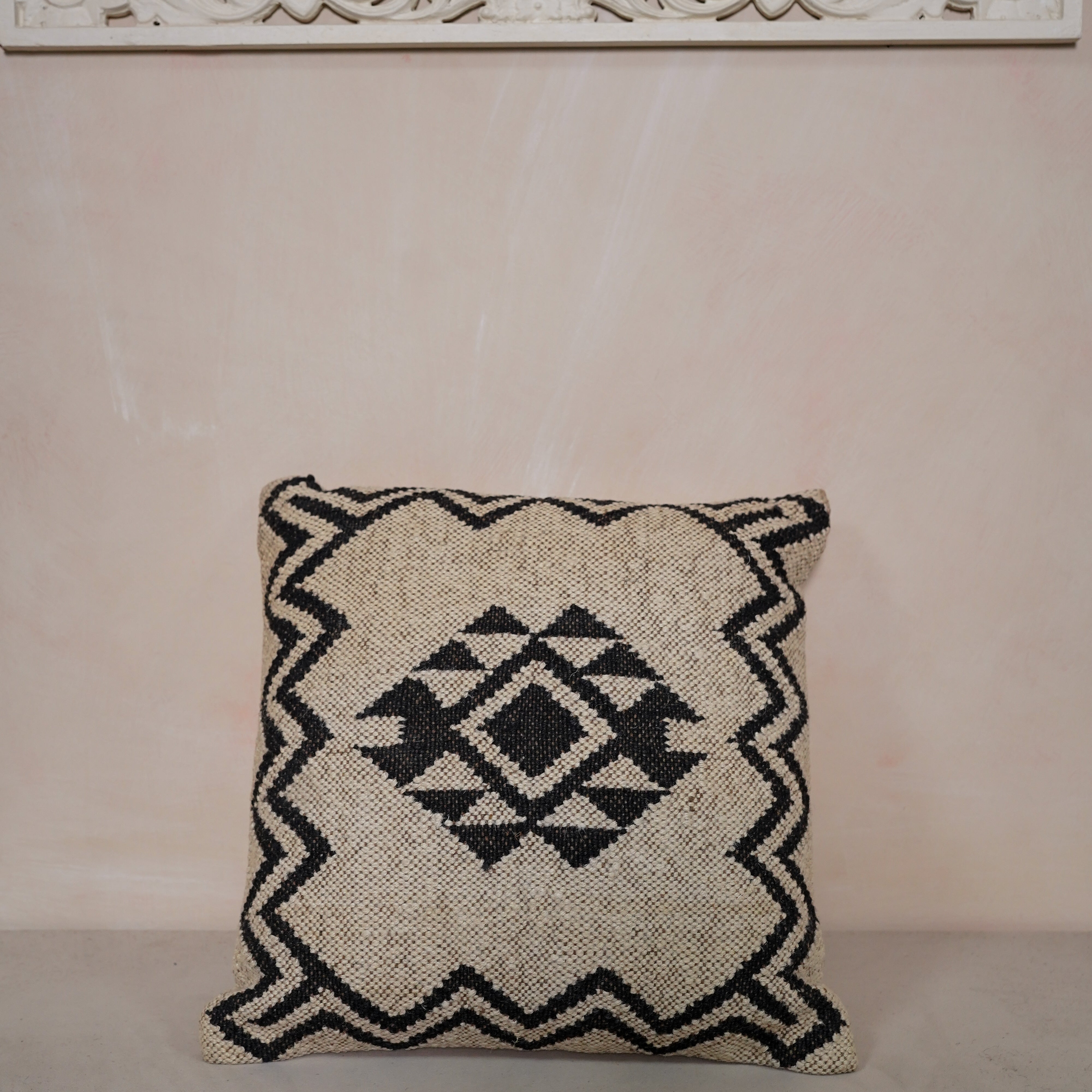 Handwoven black and ivory geometric cotton cushion cover with tribal diamond pattern for boho farmhouse living room décor.