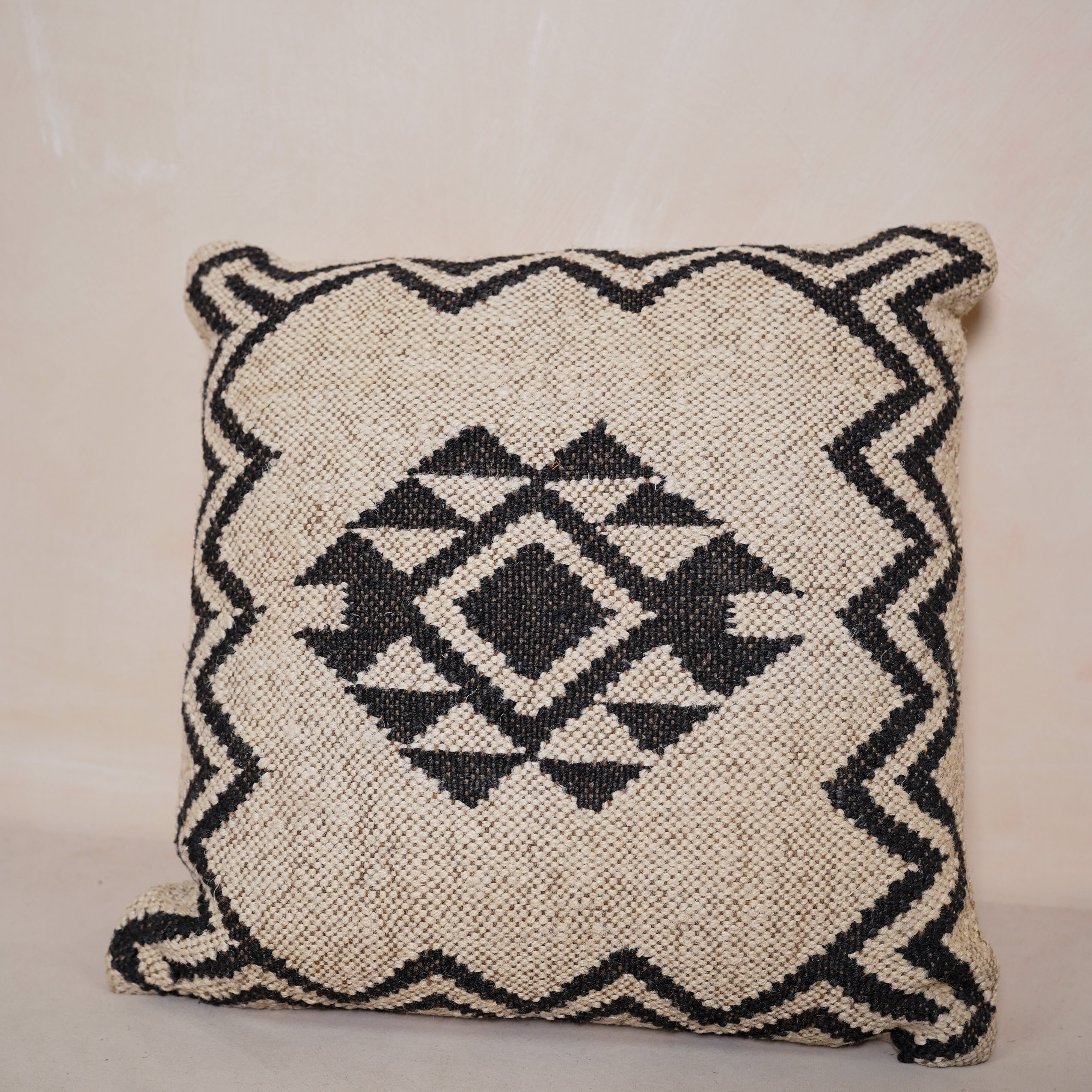 Handwoven black and ivory geometric cotton cushion cover with tribal diamond pattern for boho farmhouse living room décor.
