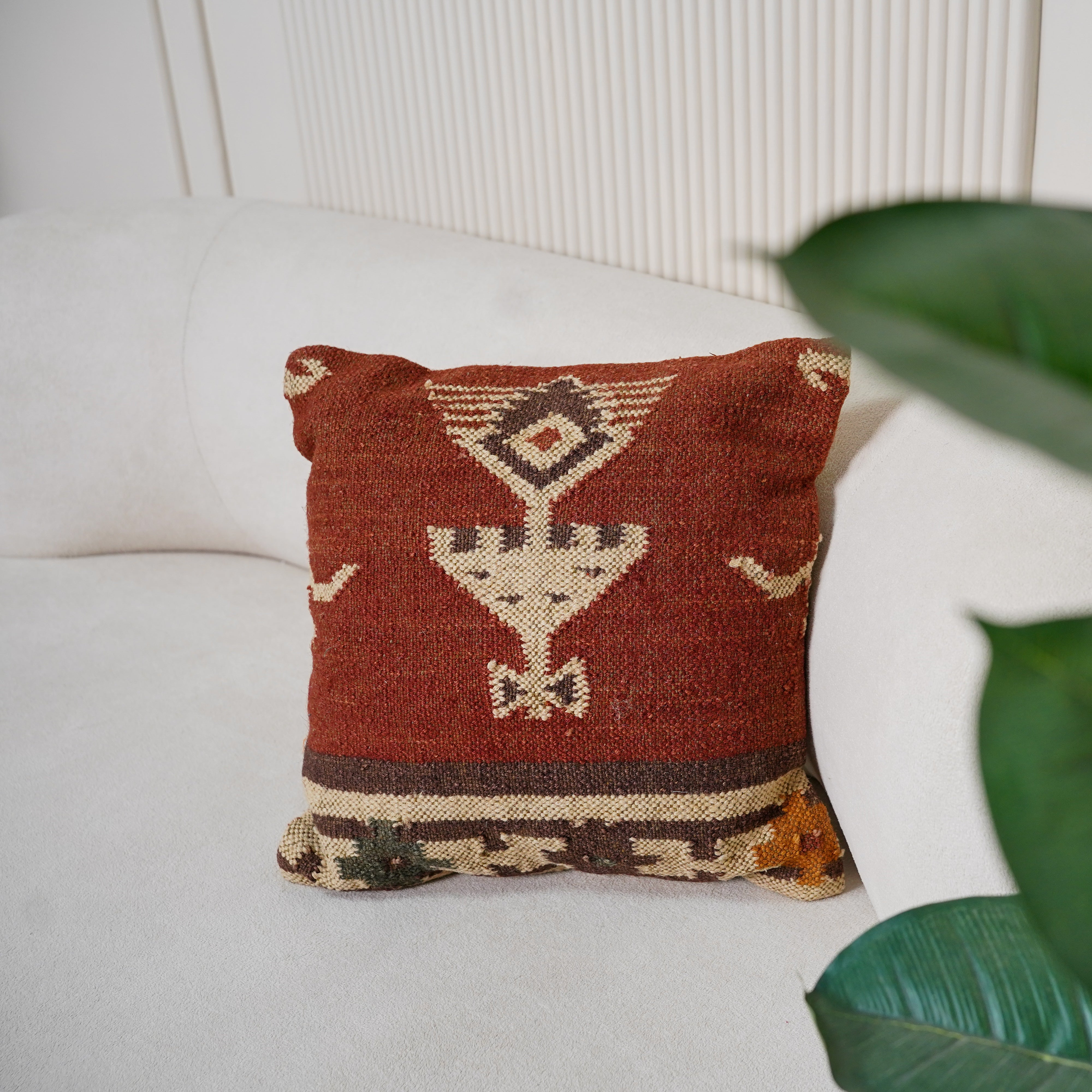 Handwoven rust red wool Kilim cushion cover featuring an ivory Southwestern tribal motif, handmade decorative throw pillow for boho, farmhouse, rustic, and modern home décor.