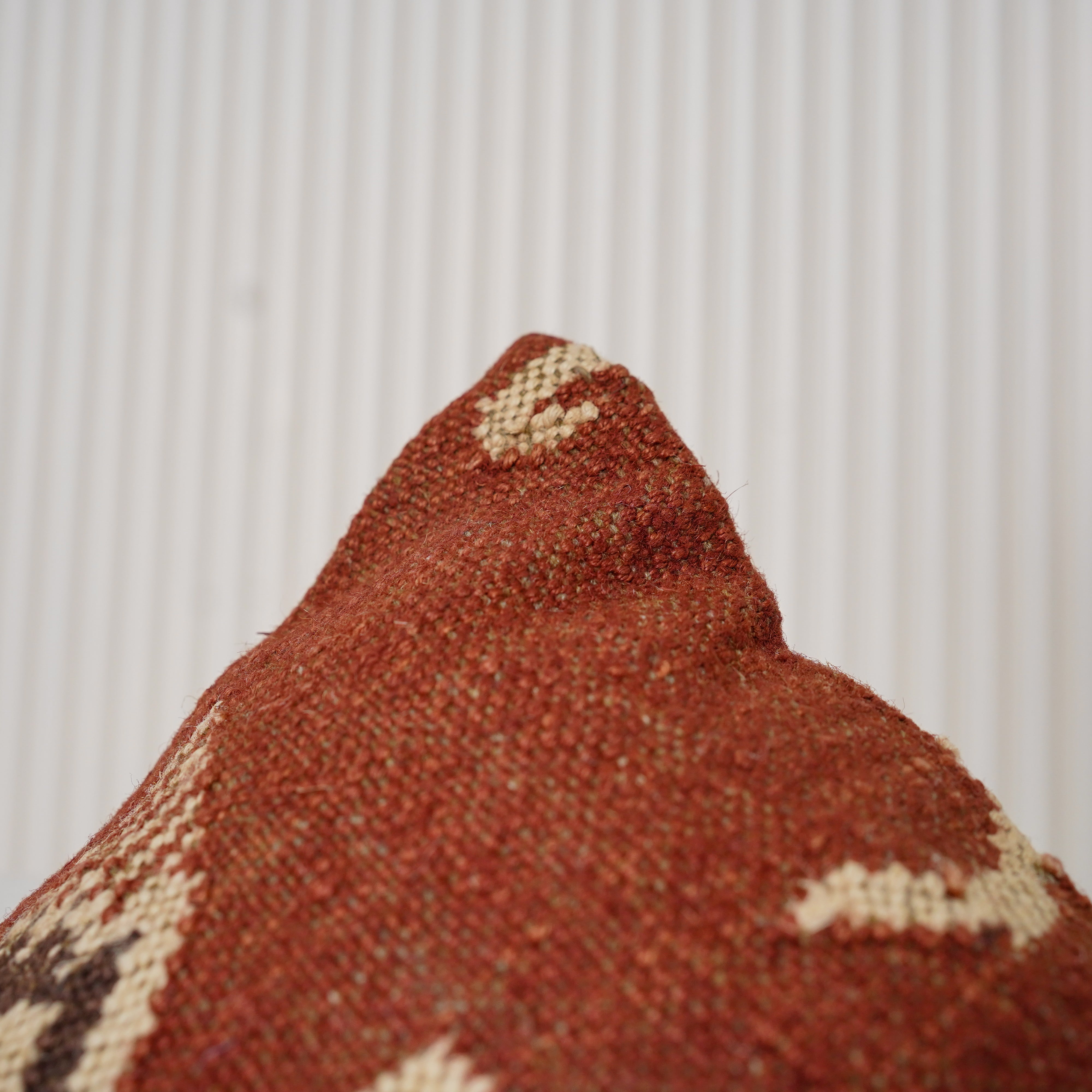 Handwoven rust red wool Kilim cushion cover featuring an ivory Southwestern tribal motif, handmade decorative throw pillow for boho, farmhouse, rustic, and modern home décor.