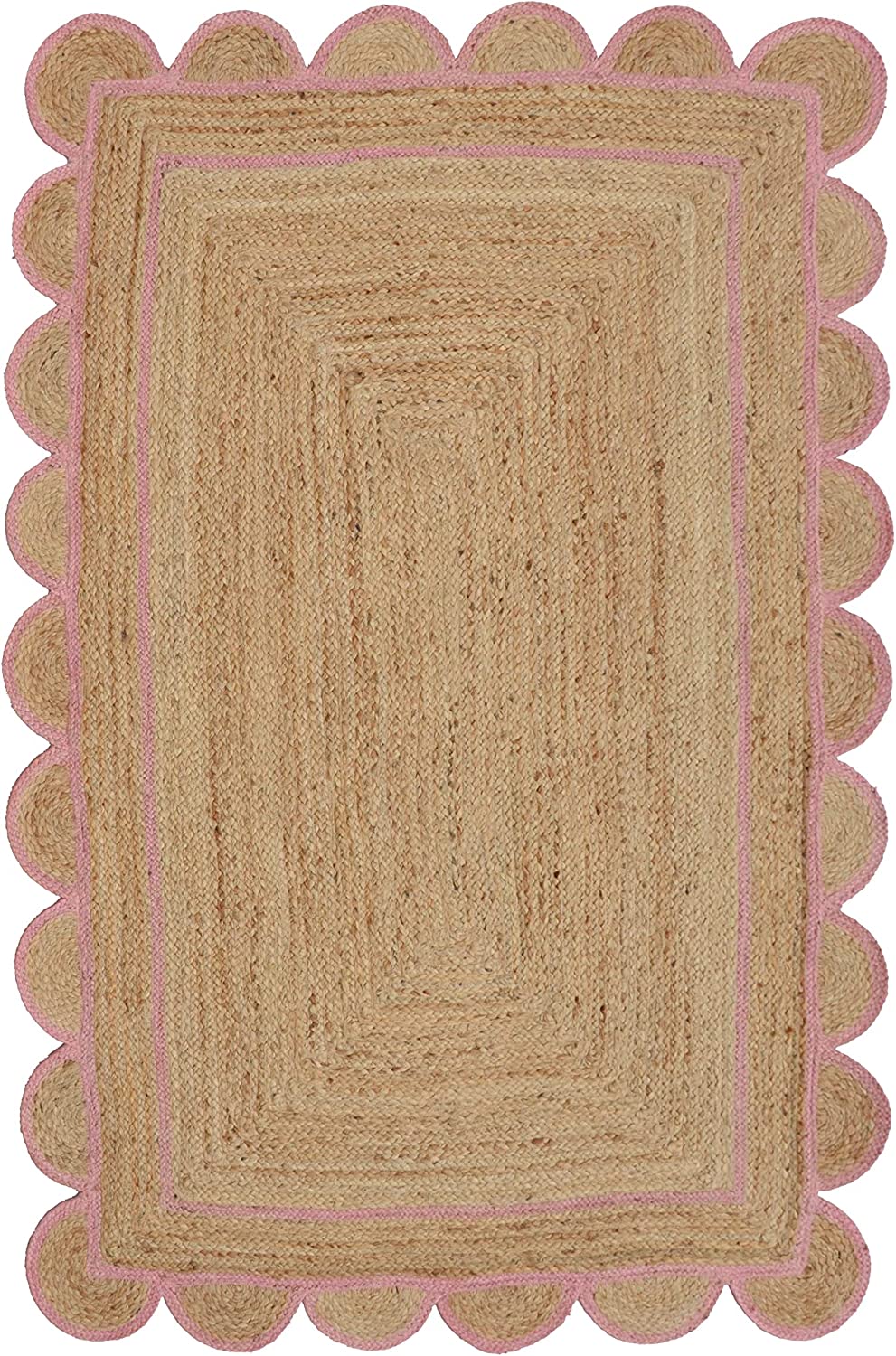 Handwoven natural jute area rug with soft pink scalloped border styled in a modern Scandinavian living room with cream sofa and wooden flooring.