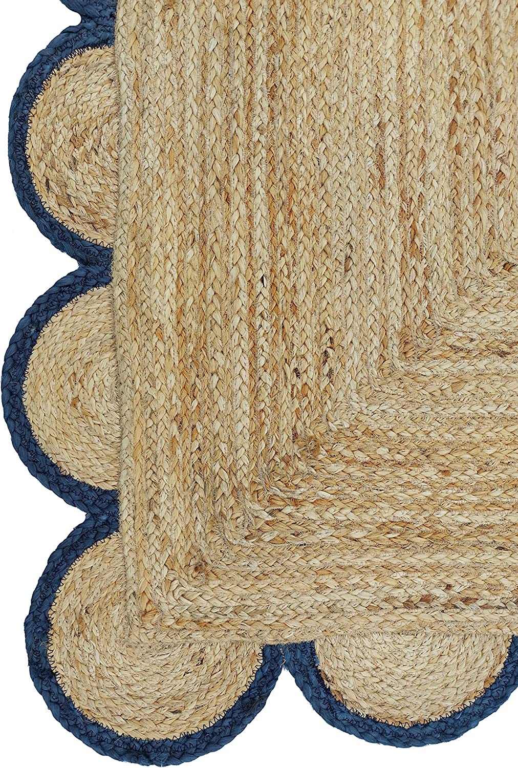 Handmade natural jute scalloped border area rug with blue trim in a bright farmhouse style living room.