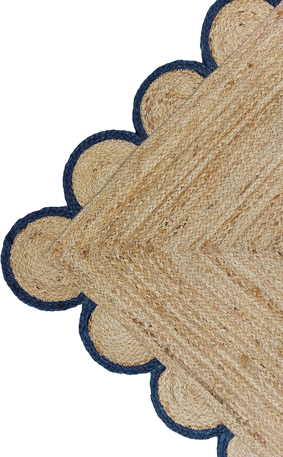 Handmade natural jute scalloped border area rug with blue trim in a bright farmhouse style living room.
