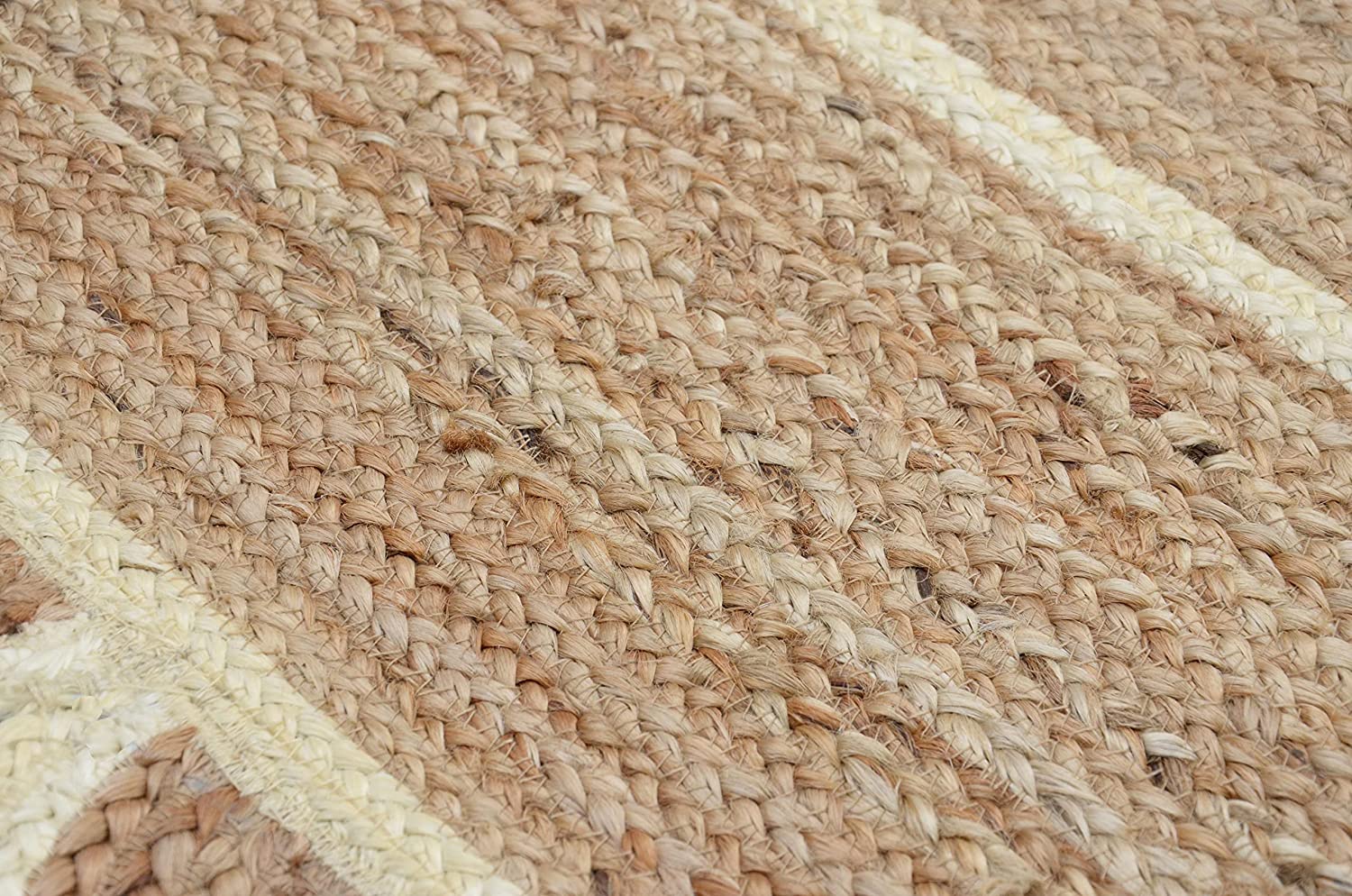 Handwoven natural jute scalloped rectangular area rug with ivory border styled in a modern Scandinavian living room.