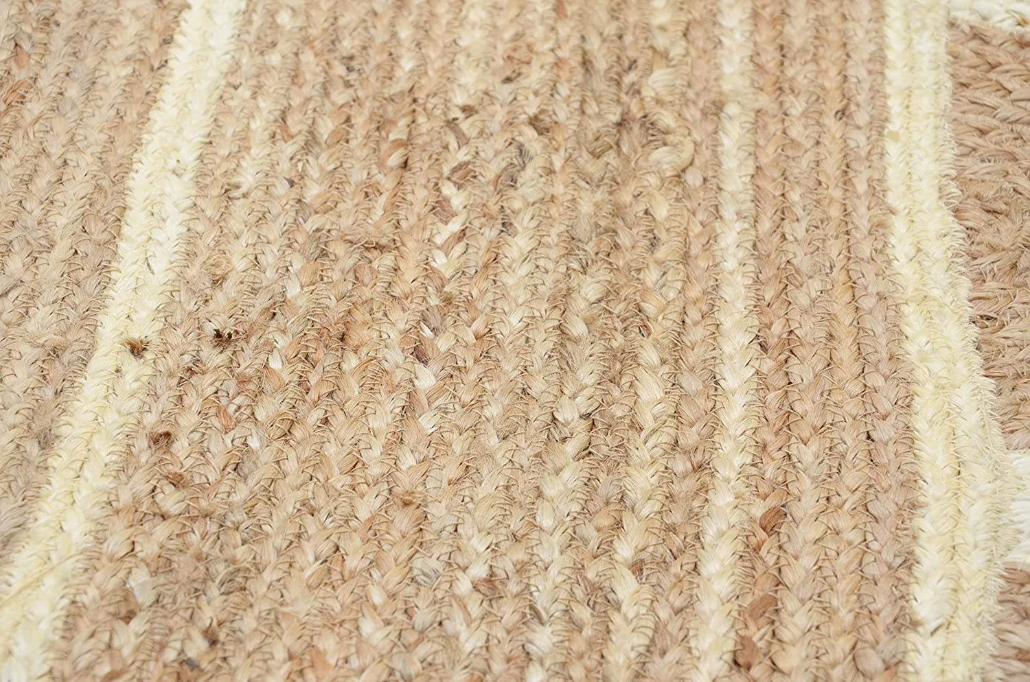 Handwoven natural jute scalloped rectangular area rug with ivory border styled in a modern Scandinavian living room.