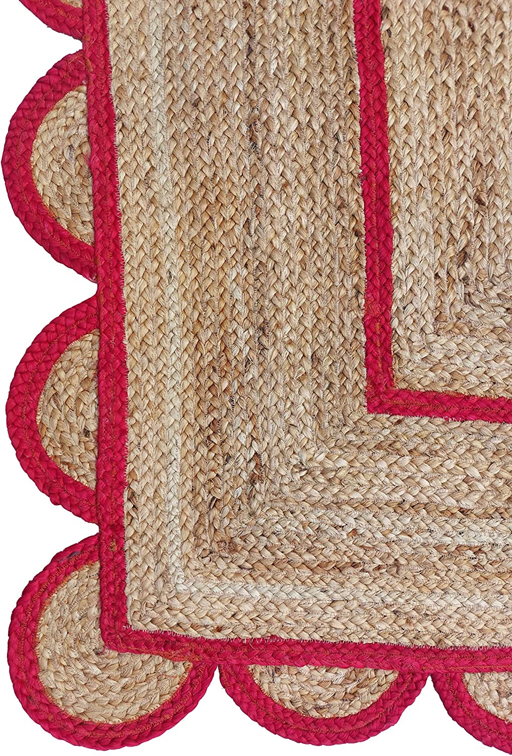 Modern living room featuring a handmade natural jute area rug with a red scalloped border, braided texture, wooden furniture, and Scandinavian boho home décor.