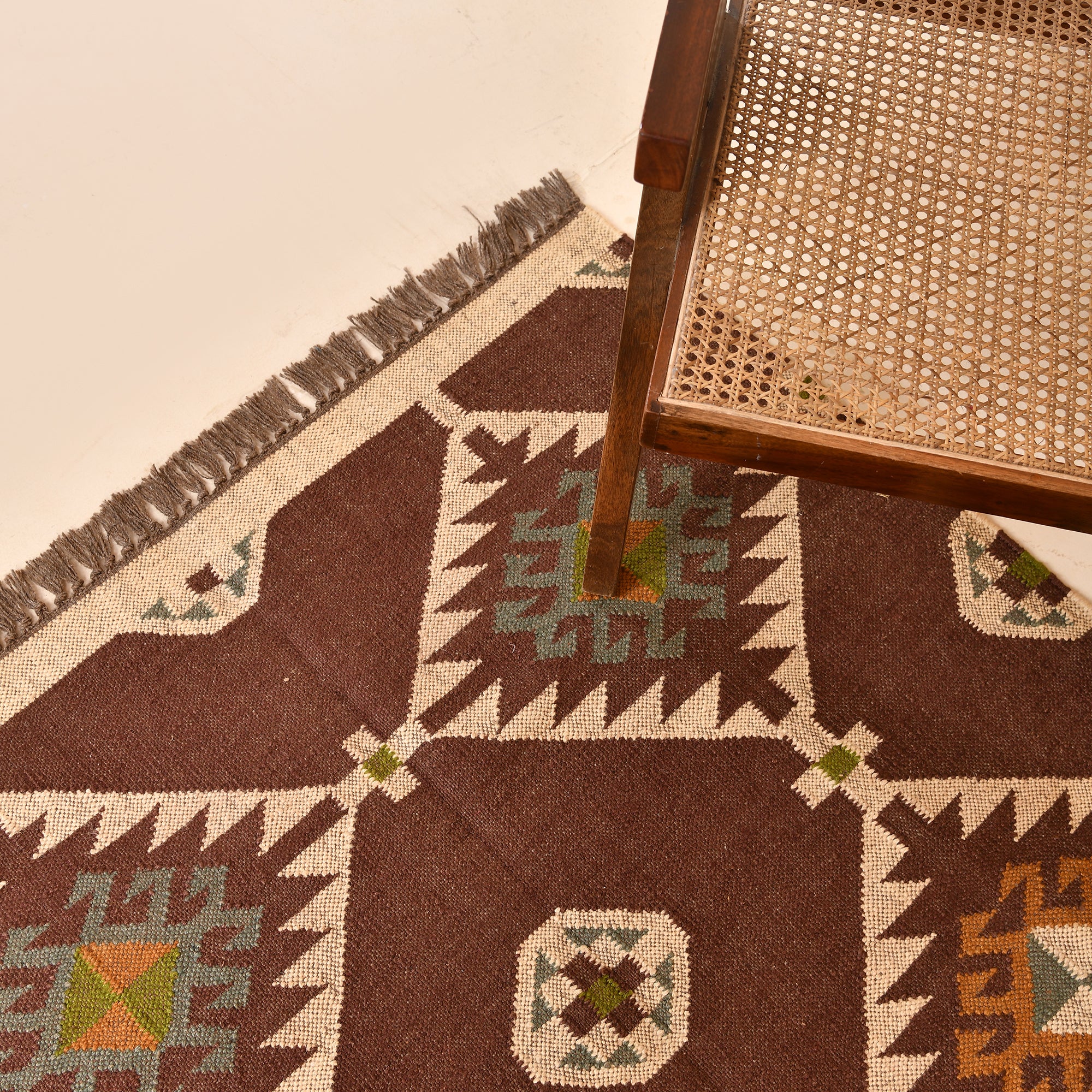 Handmade wool and jute geometric flatweave area rug in brown with tribal-inspired design for living room, bedroom, hallway, and entryway.
