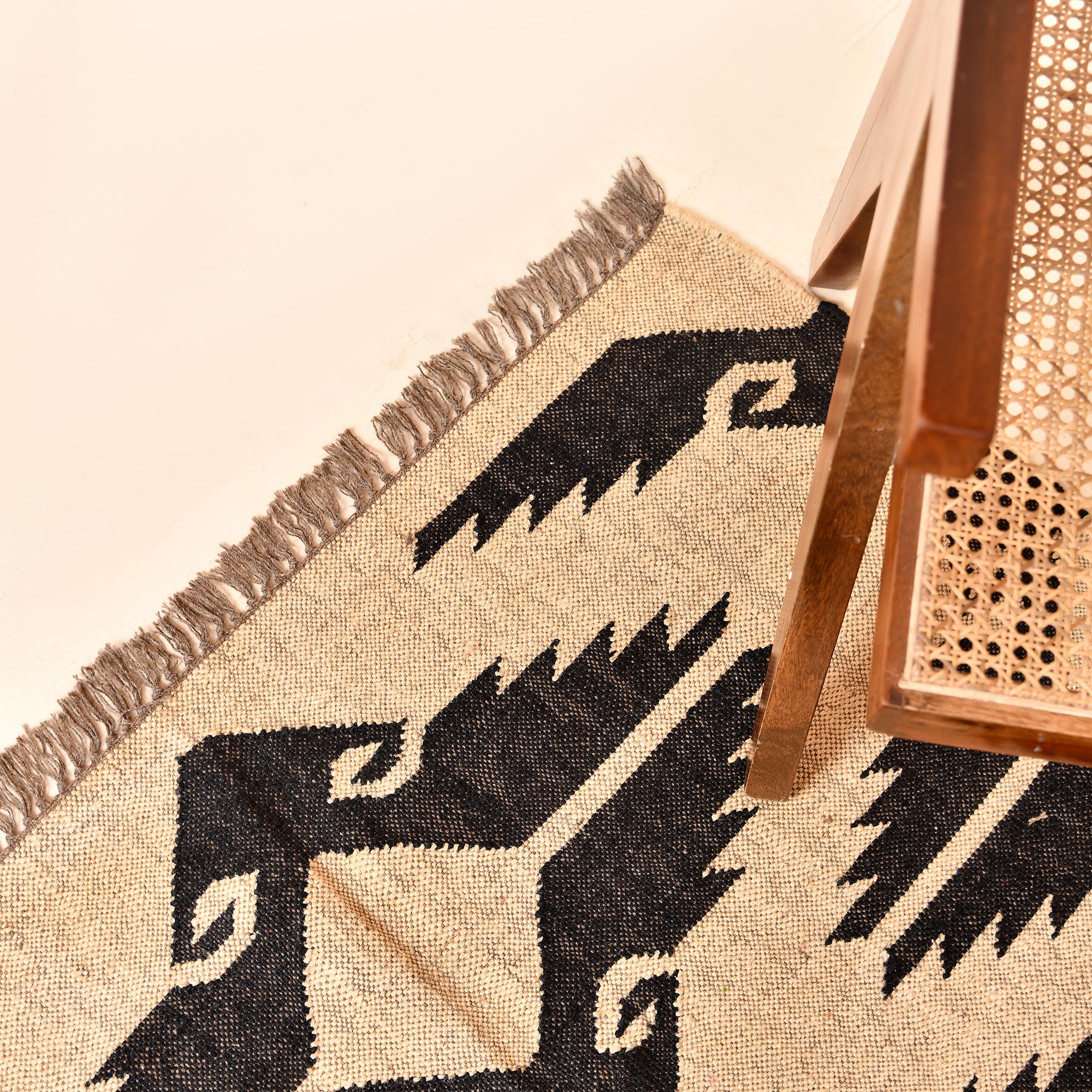 Handwoven black and ivory wool jute tribal flatweave area rug for living room and bedroom.