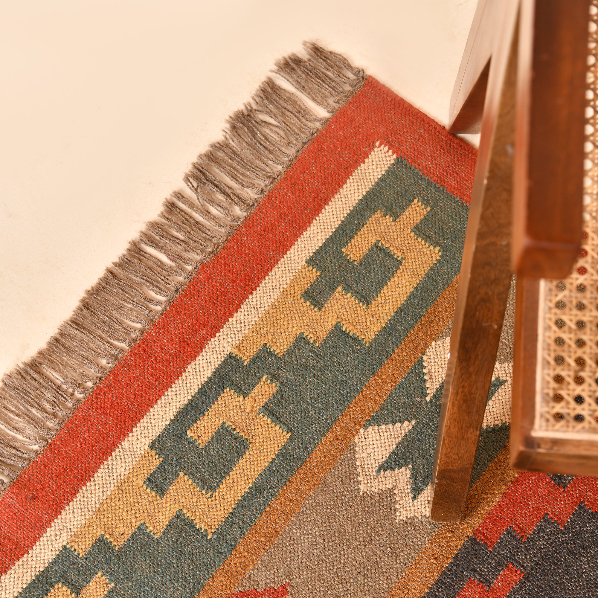 Handwoven Southwestern Kilim wool cotton area rug with colorful tribal geometric pattern in a modern living room.