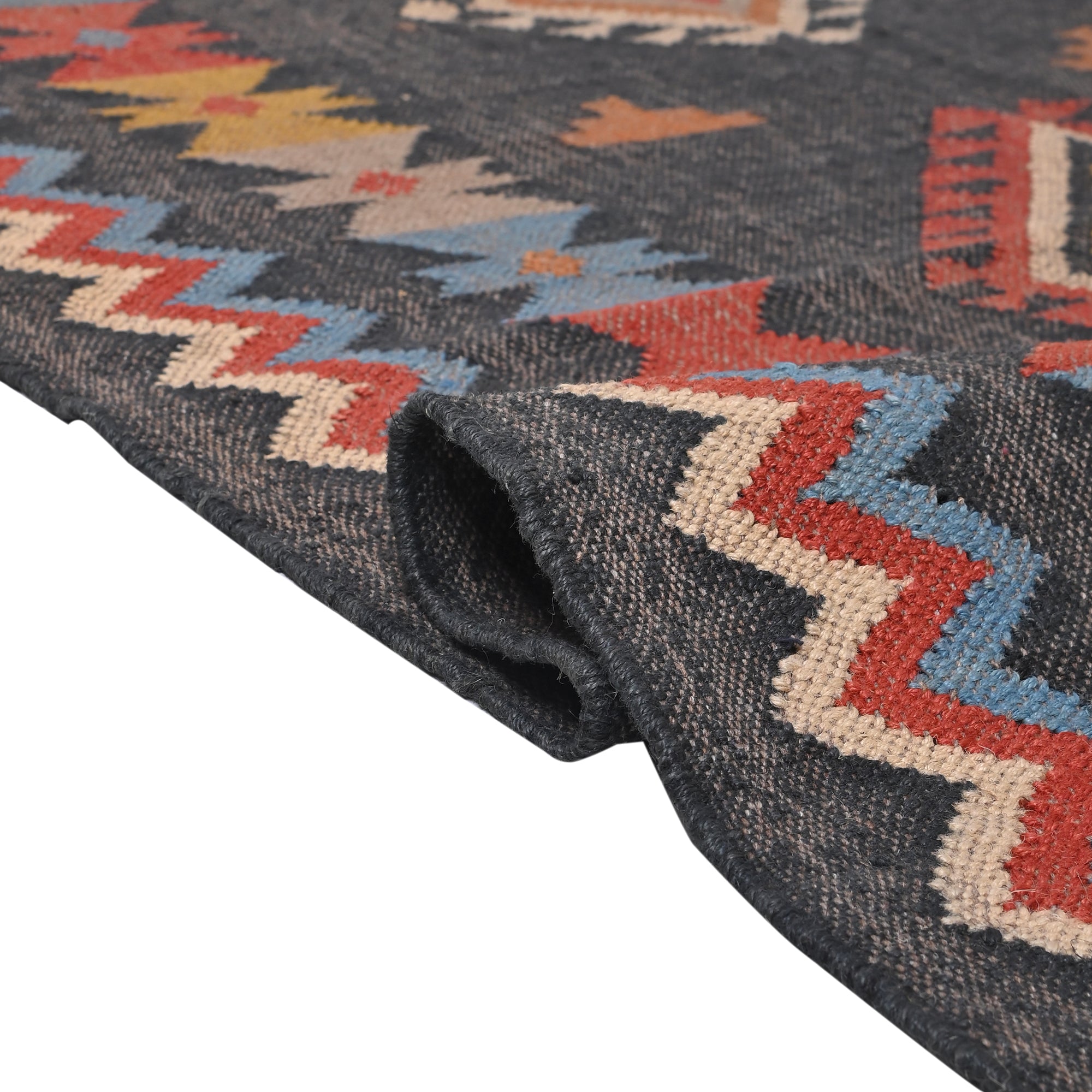 Handwoven charcoal grey wool and jute Southwestern tribal flatweave area rug with colorful geometric pattern.