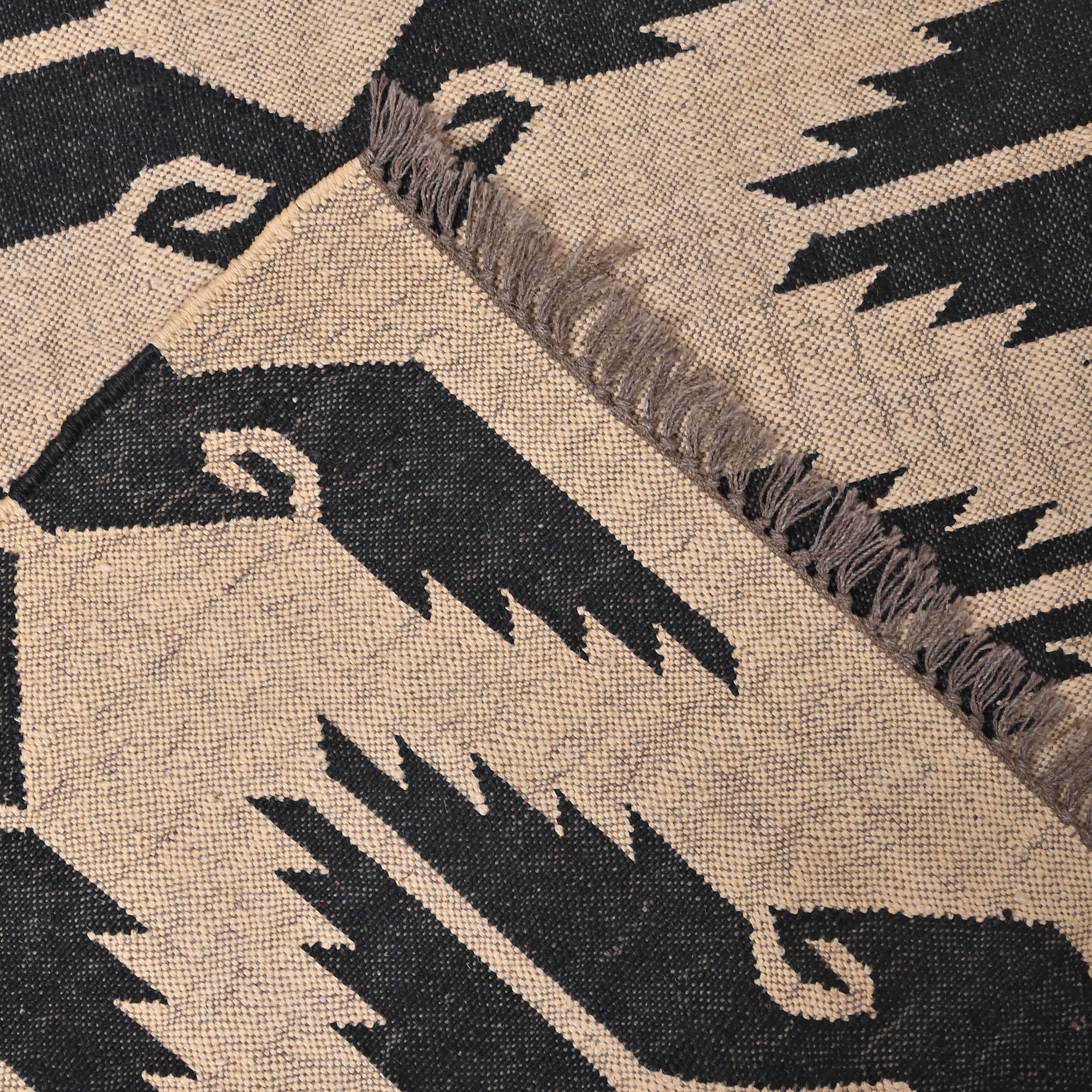 Handwoven black and ivory wool jute tribal flatweave area rug for living room and bedroom.