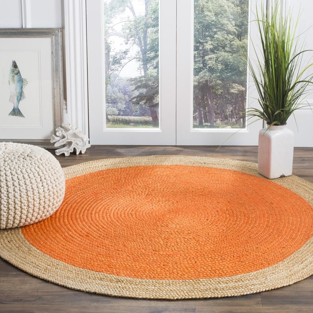 Handmade orange and natural jute round braided rug in a cozy boho living room with wooden coffee table and neutral sofa.