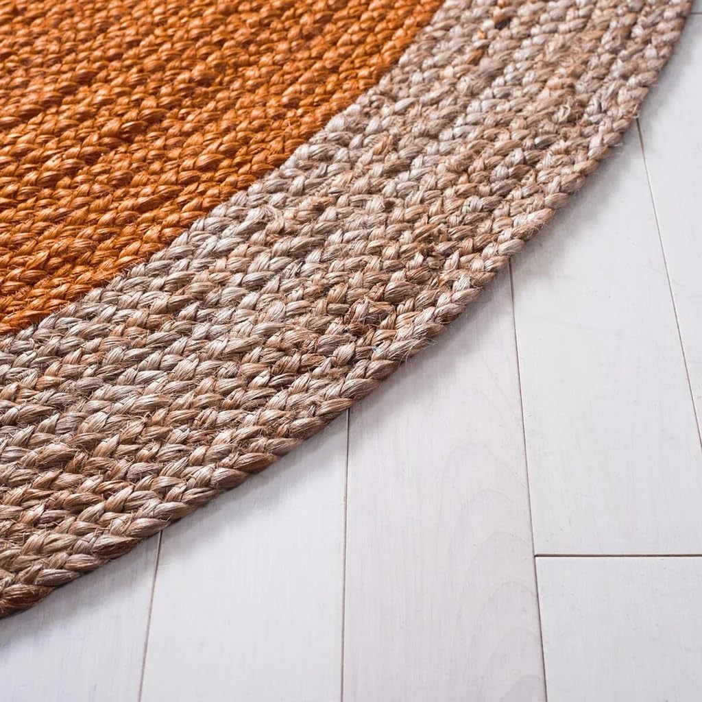 Handmade orange and natural jute round braided rug in a cozy boho living room with wooden coffee table and neutral sofa.