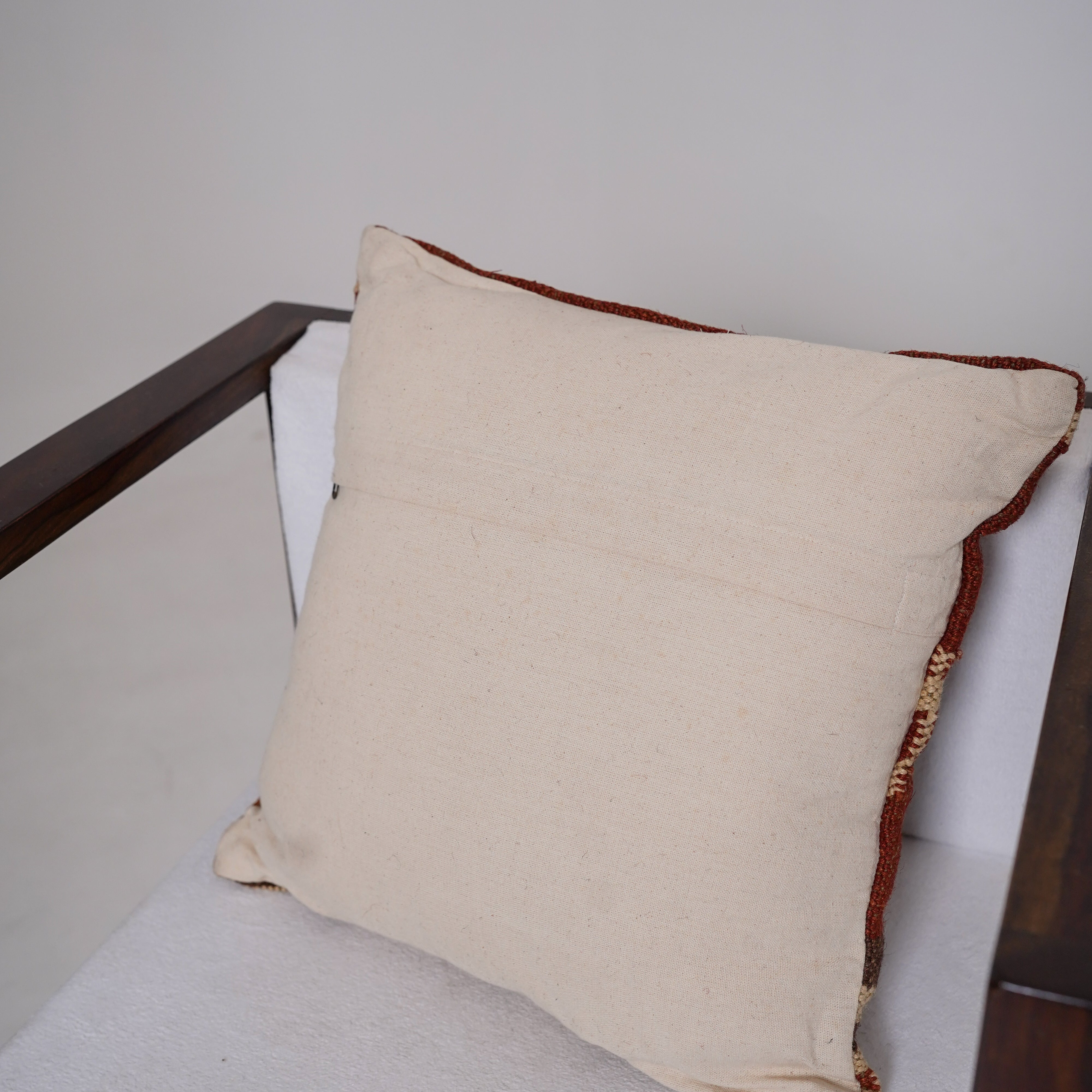 Handwoven rust red wool Kilim cushion cover featuring an ivory Southwestern tribal motif, handmade decorative throw pillow for boho, farmhouse, rustic, and modern home décor.