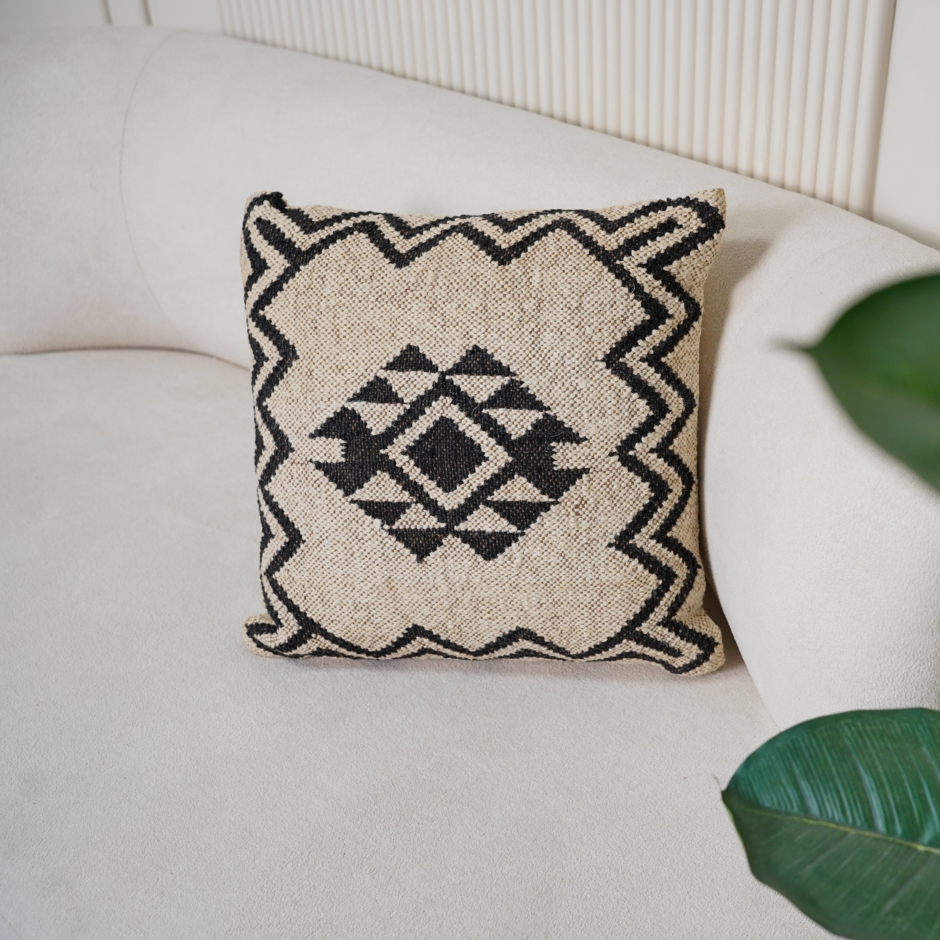 Handwoven black and ivory geometric cotton cushion cover with tribal diamond pattern for boho farmhouse living room décor.